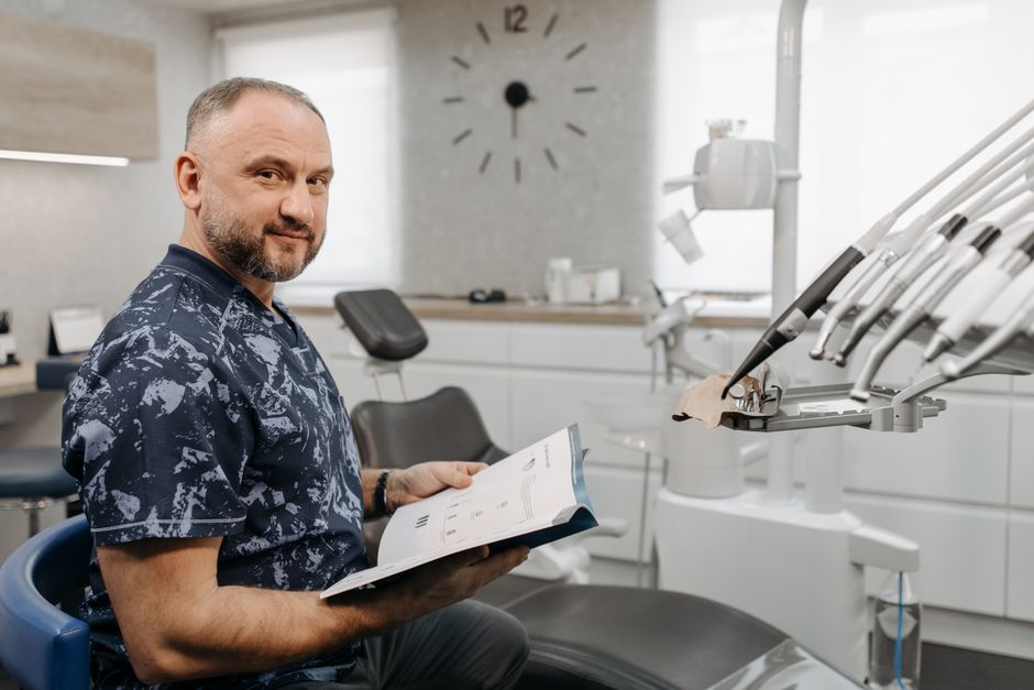 Dentist reviewing a patient's medical history and medication records before treatment